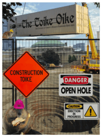Construction Toike cover. It shows a large hole edited into Front Campus, with a fence in front. On the fence are construction site signs that say, "Construction Toike" and "Danger: OPEN HOLE."